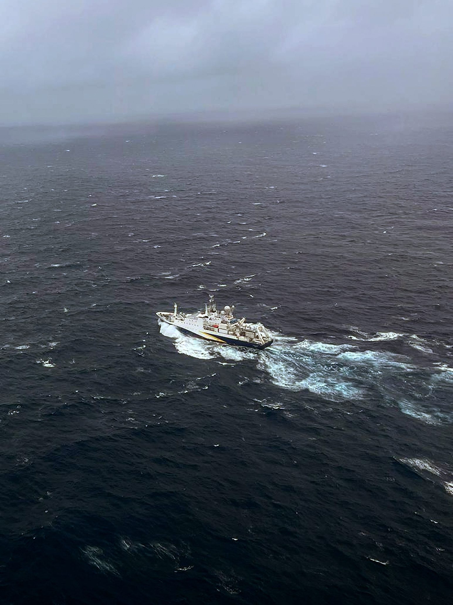 In this U.S. Coast Guard handout, a Coast Guard Air Station Elizabeth City, North Carolina HC-130 Hercules airplane flies over the French research vessel, L'Atalante approximately 900 miles East of Cape Cod during the search for the 21-foot submersible, Titan, June 21, 2023 over the Atlantic Ocean. The unified command is searching for five people after the Canadian research vessel Polar Prince lost contact with their submersible during a dive to the wreck of the Titanic on June 18, 2023. (Photo by U.S. Coast Guard via Getty Images)