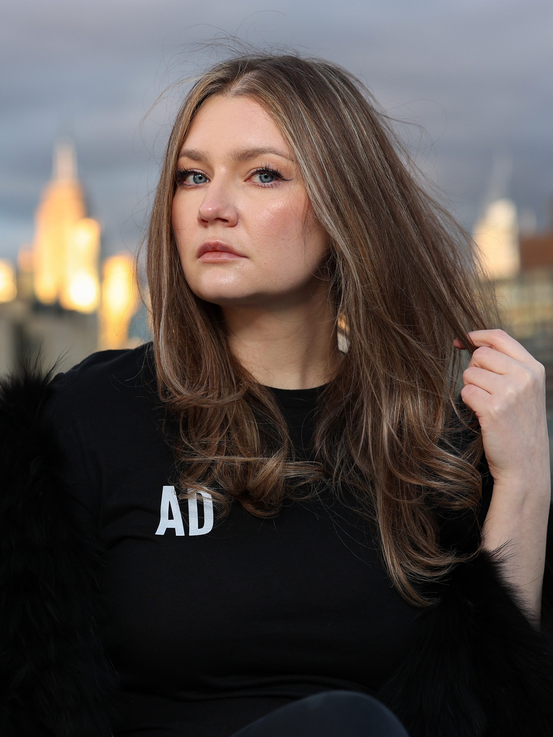 Anna Delvey poses for a photo at her home