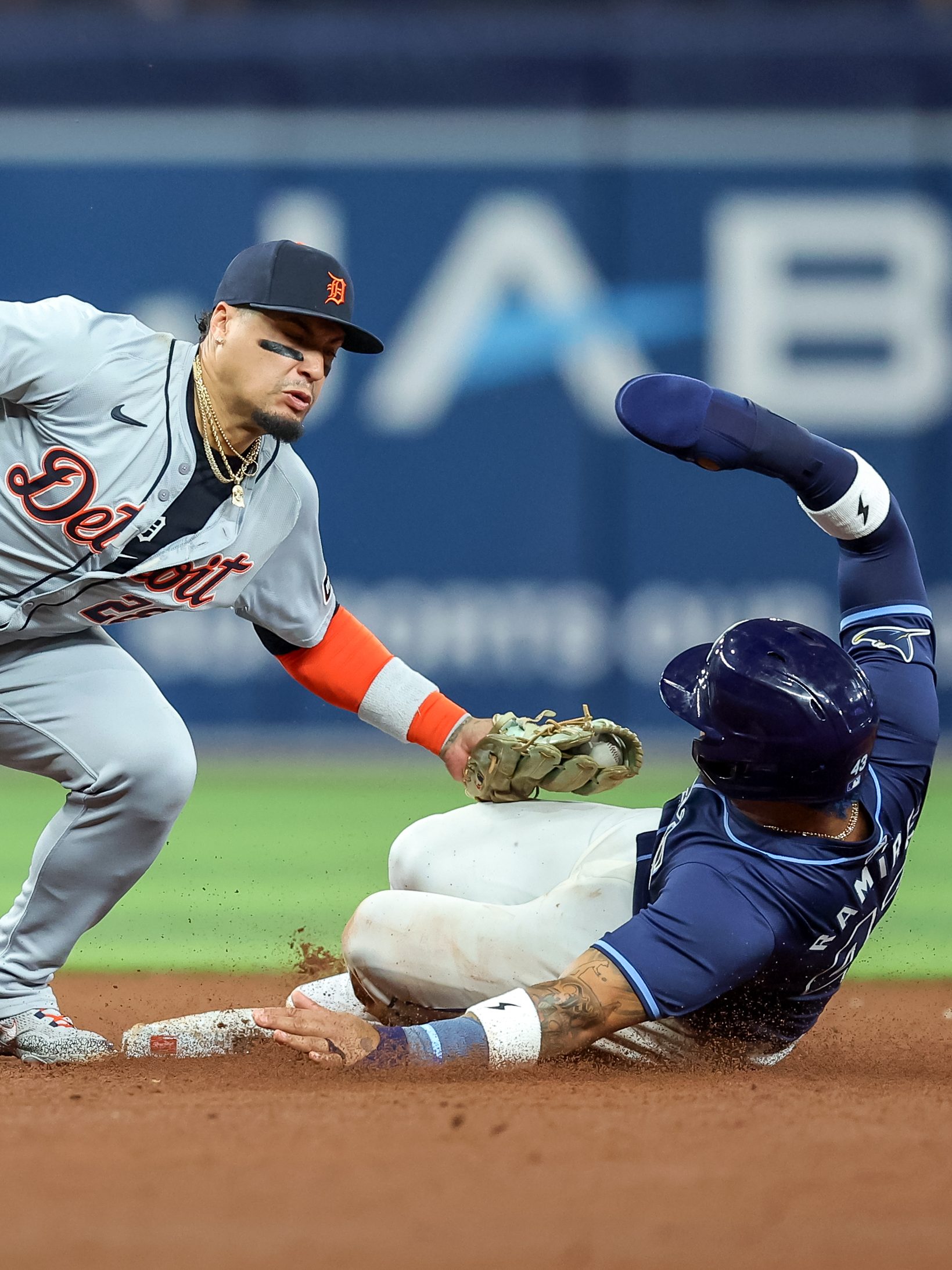 Javier Báez #28 of the Detroit Tigers tags out Harold Ramírez #43 of the Tampa Bay Rays on an attempted steal of second base as umpire Sean Barber #29 looks on during the sixth inning of a baseball game at Tropicana Field on April 23, 2024 in St. Petersburg, Florida. (Photo by Mike Carlson/Getty Images)