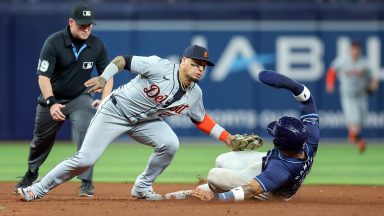 Javier Báez #28 of the Detroit Tigers tags out Harold Ramírez #43 of the Tampa Bay Rays on an attempted steal of second base as umpire Sean Barber #29 looks on during the sixth inning of a baseball game at Tropicana Field on April 23, 2024 in St. Petersburg, Florida. (Photo by Mike Carlson/Getty Images)