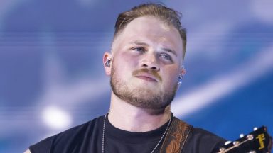 DETROIT, MICHIGAN - JUNE 20: Zach Bryan performs in support of his "The Quittin Time Tour 2024" at Ford Field on June 20, 2024 in Detroit, Michigan. (Photo by Scott Legato/Getty Images)