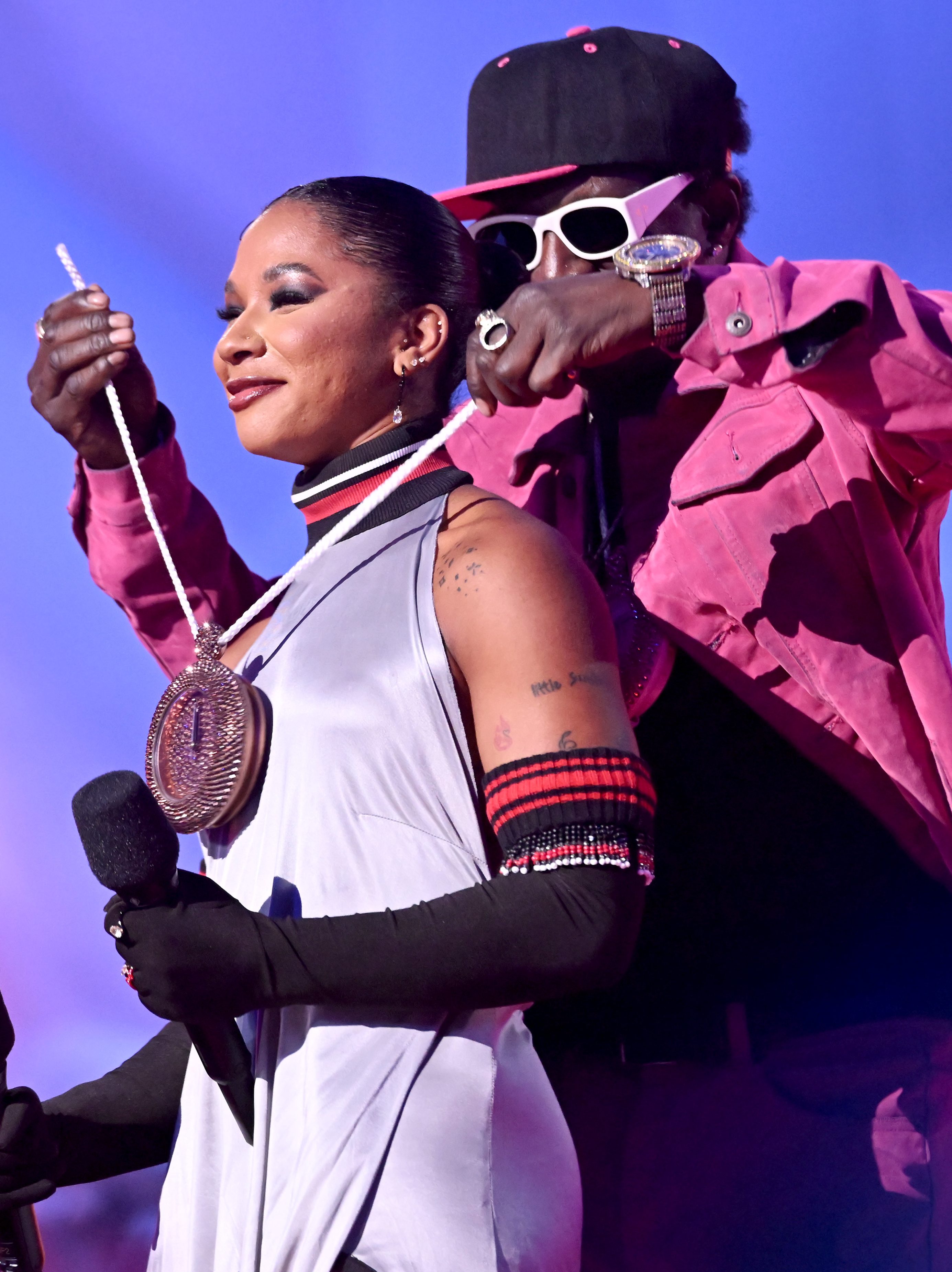ELMONT, NEW YORK - SEPTEMBER 11: (L-R) Jordan Chiles and Flavor Flav speak on stage during the 2024 MTV Video Music Awards at UBS Arena on September 11, 2024 in Elmont, New York.  (Photo by Noam Galai/Getty Images for MTV)