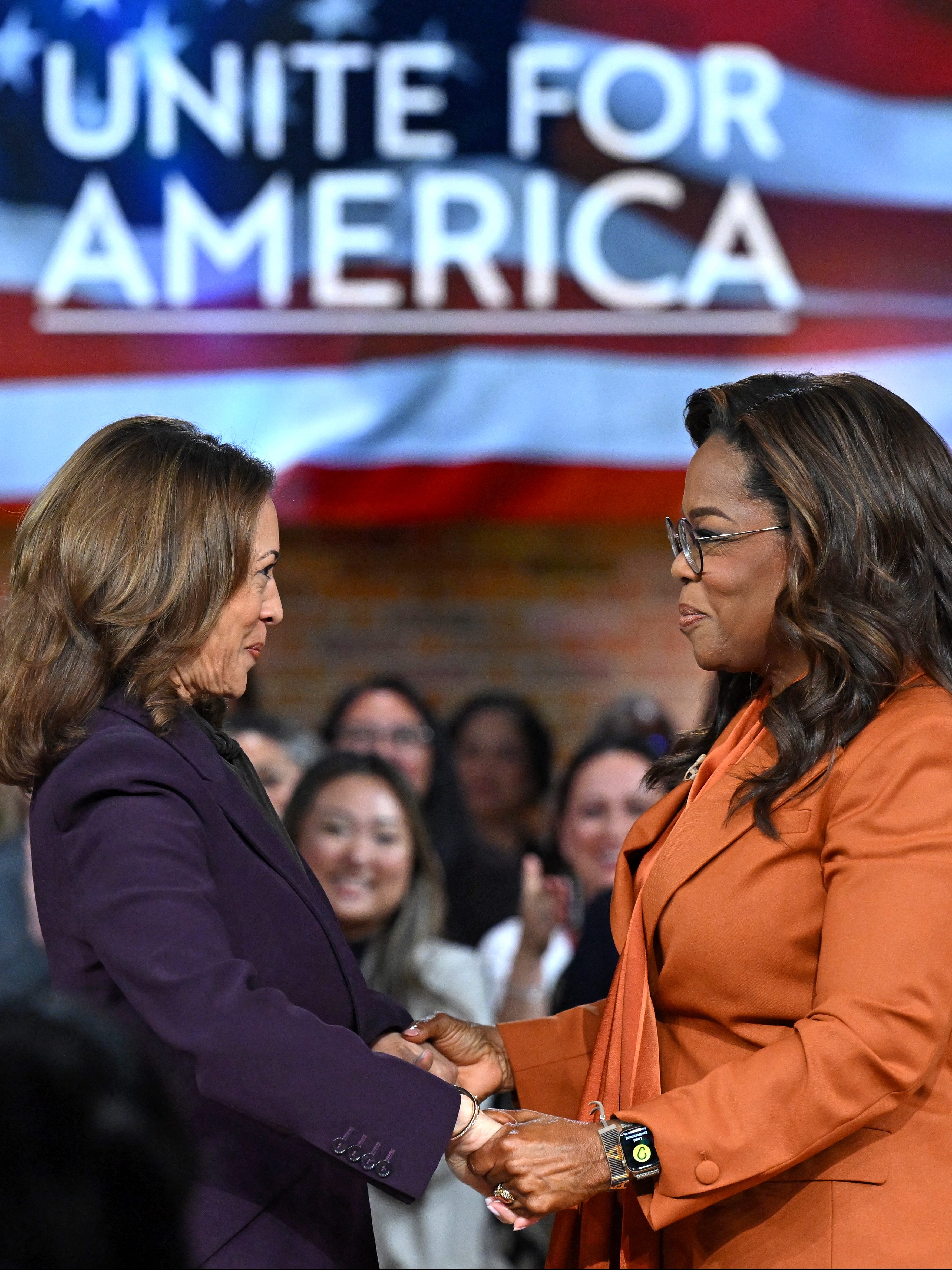 US Vice President and Democratic presidential candidate Kamala Harris (L) joins US television producer Oprah Winfrey at a 'Unite for America' live streaming rally in Farmington Hills, Michigan, on September 19, 2024. (Photo by SAUL LOEB / AFP) (Photo by SAUL LOEB/AFP via Getty Images)