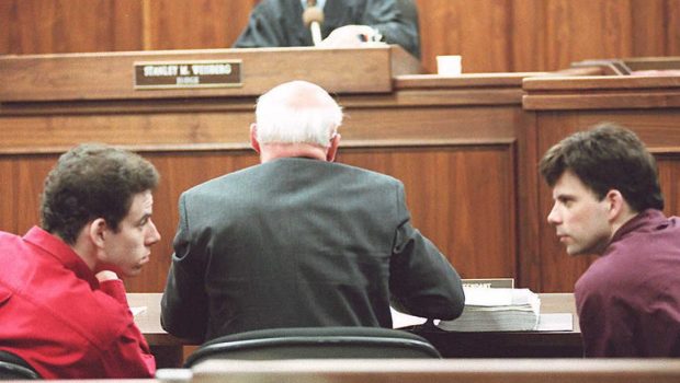 LOS ANGELES, UNITED STATES: Erik (L) and Lyle (R) Menendez converse in the courtroom during a hearing in Los Angeles, in this 02 February 1995 file picture. They are accused of murdering their parents in 1989. (Photo credit should read KIM KULISH/AFP via Getty Images)