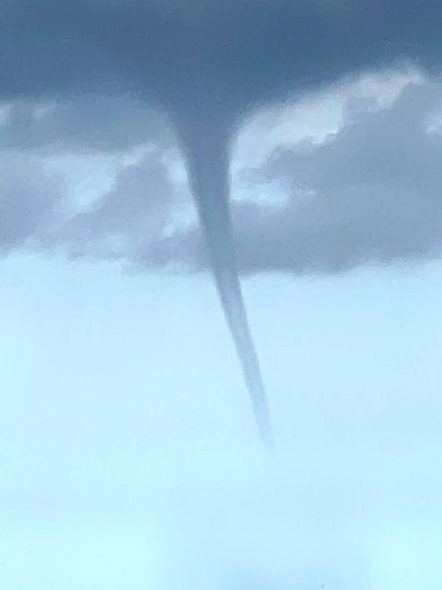 Lower Saxony, Borkum: The photo taken by a fishing boat shows a suspected tornado off the North Sea island of Borkum. A suspected tornado has caused minor devastation on the beach of the North Sea island of Borkum. On Thursday, the tornado moved from the sea over a section of the west beach and on to the promenade, as can be seen in videos on the internet. Photo: Rolf Groenewold/dpa (Photo by Rolf Groenewold/picture alliance via Getty Images)