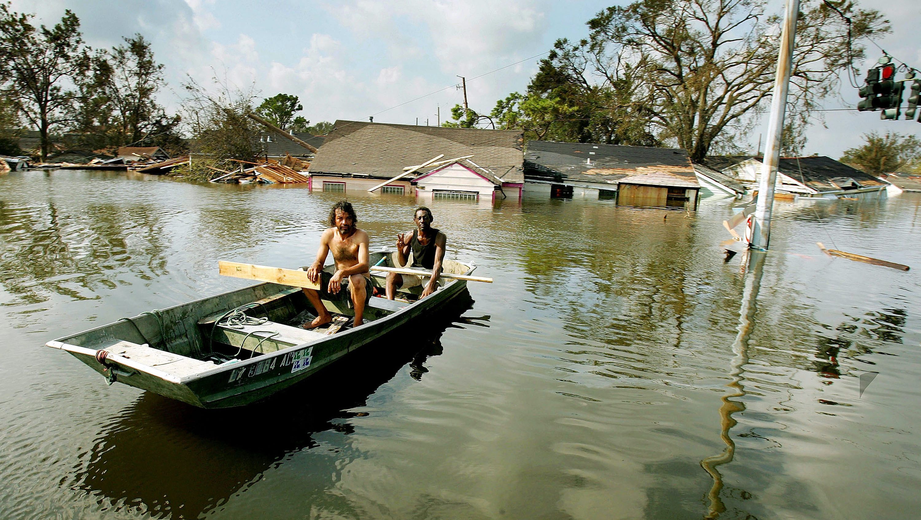 NEW ORLEANS - AUGUST 31: Two men paddle in high water in the Ninth Ward after Hurricane Katrina devastated the area August 31, 2005 in New Orleans, Louisiana. Devastation is widespread throughout the city with water approximately 12 feet high in some areas. Hundreds are feared dead and thousands were left homeless in Louisiana, Mississippi, Alabama and Florida by the storm. (Photo by Mario Tama/Getty Images)
