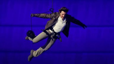 PARIS, FRANCE - AUGUST 11: Actor Tom Cruise jumps from the roof of the Stade de France during the Closing Ceremony of the Olympic Games Paris 2024  at Stade de France on August 11, 2024 in Paris, France. (Photo by Fabrizio Bensch- Pool/Getty Images)