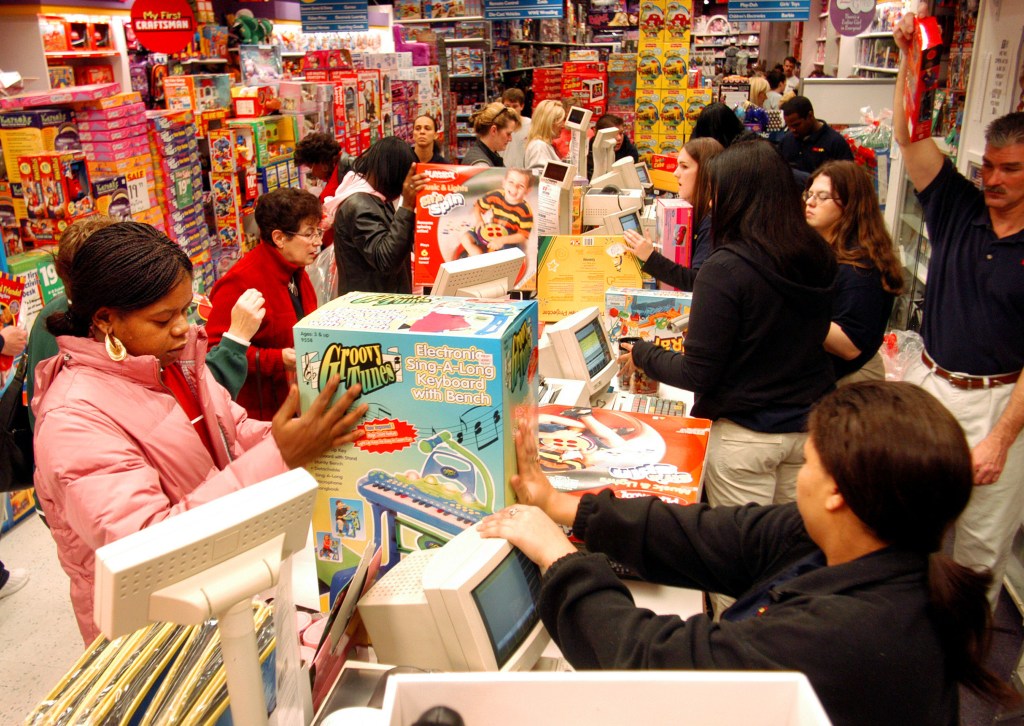 KING OF PRUSSIA, PA - NOVEMBER 28: Customers pay for their items while doing their Black Friday shopping at KB Toys, which opened at 5am, in the King of Prussia Mall November 28, 2003 in King of Prussia, Pennsylvania. Black Friday is traditionally when stores get out of the red and start making a profit for the year. Economists expect a 5 percent increase in holiday sales over last year. (Photo by William Thomas Cain/Getty Images)