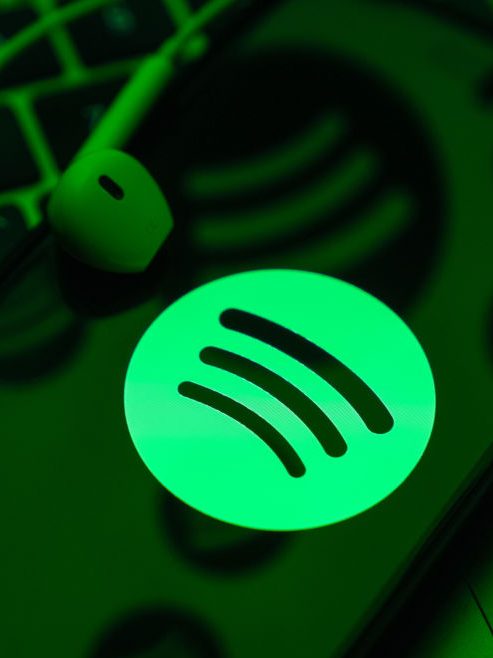 ANKARA, TURKIYE - MAY 01: In this photo illustration a mobile phone screen displaying Spotify logo with a headset onto it, in Ankara, Turkiye on May 01, 2024. (Photo by Dilara Irem Sancar/Anadolu via Getty Images)