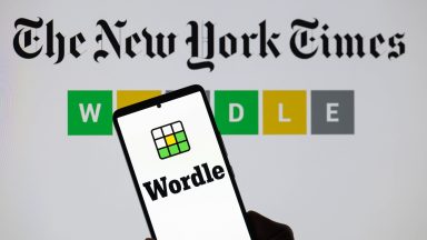 The Wordle logo is being displayed on a smartphone with The New York Times visible in the background in this photo illustration in Brussels, Belgium, on June 1, 2024. (Photo by Jonathan Raa/NurPhoto)