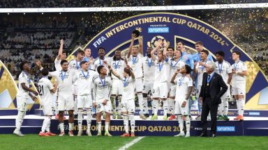 DOHA, QATAR - DECEMBER 18: Kylian Mbappe of Real Madrid lifts the 2024 FIFA Intercontinental Cup trophy as Real Madrid players celebrate their victory at the end of the FIFA Intercontinental Cup between Real Madrid and CF Pachuca at Lusail Stadium on December 18, 2024 in Doha, Qatar.  (Photo by Christopher Pike - FIFA/FIFA via Getty Images)