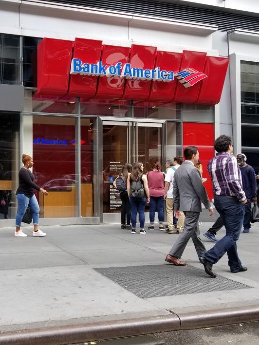 People walk past the Bank of America branch near Penn Station in Times Square, New York City, New York, September 15, 2017. (Photo by Smith Collection/Gado/Getty Images)