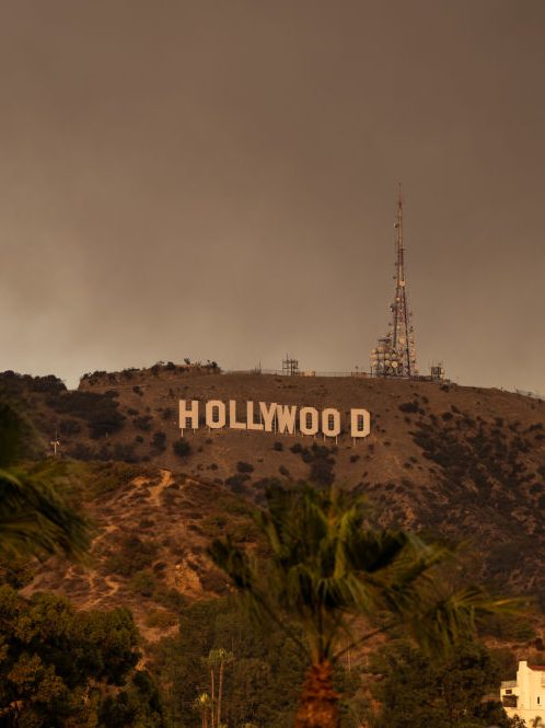 HOLLYWOOD, CA - JANUARY 08: The Hollywood Sign is seen with smoke from multiple wildfires on January 08, 2025 in Hollywood, California.  (Photo by AaronP/Bauer-Griffin/GC Images)