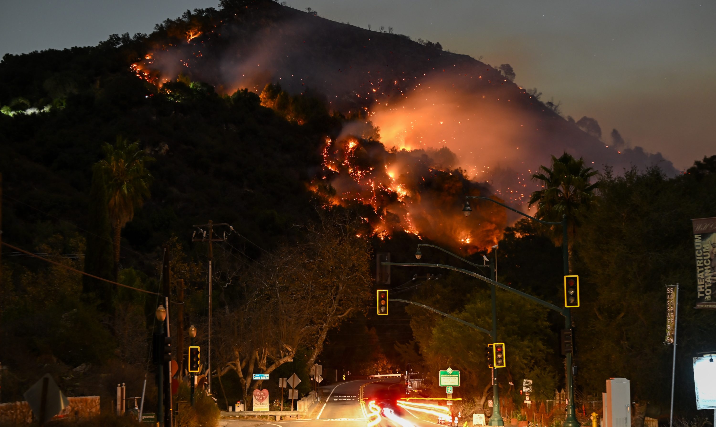 LOS ANGELES, CALIFORNIA - JANUARY 9: A view of flames at the mountain as seen from Topanga Canyon near Pacific Palisades in Topanga, Los Angeles, California, United States on January 9, 2025. A fast-moving wildfire has forced 180,000 people to evacuate, with officials warning that worsening winds could further escalate the blaze. (Photo by Tayfun Coskun/Anadolu via Getty Images)