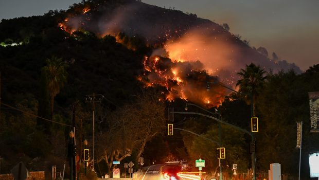 LOS ANGELES, CALIFORNIA - JANUARY 9: A view of flames at the mountain as seen from Topanga Canyon near Pacific Palisades in Topanga, Los Angeles, California, United States on January 9, 2025. A fast-moving wildfire has forced 180,000 people to evacuate, with officials warning that worsening winds could further escalate the blaze. (Photo by Tayfun Coskun/Anadolu via Getty Images)