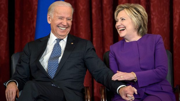 US Vice President Joe R. Biden (L) and former Secretary of State Hillary Clinton laugh during a portrait unveiling for outgoing Senate Minority Leader Senator Harry Reid (D-NV) on Capitol Hill December 8, 2016 in Washington, DC. / AFP / Brendan Smialowski (Photo credit should read BRENDAN SMIALOWSKI/AFP via Getty Images)