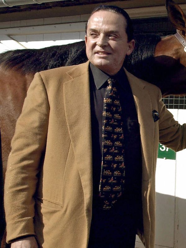 A photo taken 07 March 2002 in Deauville, western France, shows art dealer and horse owner Alec Wildenstein (L) posing with his horse Kesaco Phedo, winner of the three-year Criterium and of the Prix de Vincennes. Alec Wildenstein died 18 February 2008 in Paris.   AFP PHOTO MYCHELE DANIAU (Photo credit should read MYCHELE DANIAU/AFP via Getty Images)